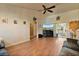 Spacious living area features wood flooring, ceiling fan and access to the outside through sliding glass doors at 2011 Oakbend Dr, Eustis, FL 32726