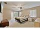 Spacious main bedroom with a ceiling fan, carpet floors, and a sliding glass door to the outside at 2011 Oakbend Dr, Eustis, FL 32726