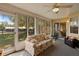 Inviting sunroom with ample natural light, ceiling fan, and pleasant views of the outdoors at 2011 Oakbend Dr, Eustis, FL 32726