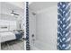 A close-up of a well-maintained bathroom with a shower and tub combo next to a peek into the bright bedroom at 202 E South St # 5046, Orlando, FL 32801