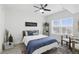 Bright bedroom featuring natural light, a ceiling fan, a decorative rug, and a modern minimalist design at 202 E South St # 5046, Orlando, FL 32801