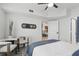 Bright bedroom with a ceiling fan, an open door and sight-line to the modern kitchen and living area at 202 E South St # 5046, Orlando, FL 32801