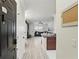 Inviting entryway of condo unit, showcasing the light gray wood floors and a glimpse into the living room at 202 E South St # 5046, Orlando, FL 32801