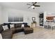 Bright living room featuring a modern ceiling fan, decorative shelving, and a comfortable leather sectional sofa at 202 E South St # 5046, Orlando, FL 32801
