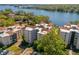 Condo community aerial view showcasing the beautiful waterfront and multiple condo buildings with red tile roofs at 204 Quayside Cir # 501, Maitland, FL 32751