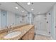 Bathroom features a double sink vanity with granite countertop and a glass enclosed walk-in shower at 204 Quayside Cir # 501, Maitland, FL 32751