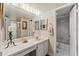 Cozy bathroom with vanity sink and mirror, adjacent toilet and bathtub with white tiled walls at 204 Quayside Cir # 501, Maitland, FL 32751