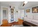 Spare bedroom with hardwood floors, a white sofa, and built-in shelving for storage and display at 204 Quayside Cir # 501, Maitland, FL 32751