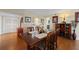 Dining area with wooden table, seating for six, hardwood floors and adjacent pass through to the kitchen at 204 Quayside Cir # 501, Maitland, FL 32751