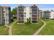 Well-maintained condo building featuring screened patios and lush green landscaping at 204 Quayside Cir # 501, Maitland, FL 32751