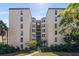 Beautifully maintained condo building with lush greenery and a well-manicured walkway at 204 Quayside Cir # 501, Maitland, FL 32751