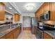 Well-lit kitchen features granite countertops, stainless steel appliances and adjacent dining area at 204 Quayside Cir # 501, Maitland, FL 32751