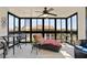 Enclosed sunroom filled with natural light, offering a relaxing space with comfortable seating at 204 Quayside Cir # 501, Maitland, FL 32751