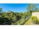 A fenced backyard view with lush greenery and a wrought iron fence at 2144 Rookery Ln, Sanford, FL 32773