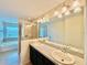 Bathroom vanity featuring double sinks, granite countertops, walk-in shower, and soaking tub at 2144 Rookery Ln, Sanford, FL 32773
