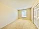 Bedroom featuring a window, spacious closet, and neutral carpet at 2144 Rookery Ln, Sanford, FL 32773