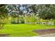 Serene community park with lush green grass and mature trees at 2144 Rookery Ln, Sanford, FL 32773