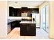 Modern kitchen with stainless steel appliances, granite counters, and dark wood cabinets at 2144 Rookery Ln, Sanford, FL 32773