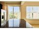 Bright kitchen with a granite island and a stainless steel refrigerator, with a sliding glass door view to the outside at 2144 Rookery Ln, Sanford, FL 32773