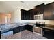 Modern kitchen featuring dark cabinets, stainless steel appliances, and granite countertops for a sleek look at 2144 Rookery Ln, Sanford, FL 32773