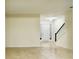 Open living room with tile flooring, bright natural light, and staircase, ideal for Gathering gatherings and entertaining at 2144 Rookery Ln, Sanford, FL 32773