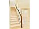 Carpeted staircase with a wooden handrail provides access to the upper level, located in a well-lit area at 2144 Rookery Ln, Sanford, FL 32773