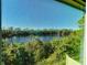 Scenic view of a lake surrounded by lush greenery from a screened-in window at 2144 Rookery Ln, Sanford, FL 32773