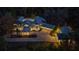 Aerial night view of an estate with illuminated exteriors, garages, and a long paver driveway at 2240 W Dale Cir, Deland, FL 32720