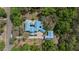 Overhead aerial view of the home with a light blue roof surrounded by mature trees at 2240 W Dale Cir, Deland, FL 32720
