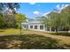 Beautiful backyard with screened in porch, large grassy area, and mature trees at 2240 W Dale Cir, Deland, FL 32720