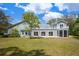 Wide view of backyard with screened in porch, sun room, and patio at 2240 W Dale Cir, Deland, FL 32720