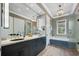 Stylish bathroom with double vanity, elegant fixtures, a soaking tub, and a glass-enclosed shower at 2240 W Dale Cir, Deland, FL 32720
