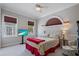 Charming bedroom with a tufted headboard, television, sconces, and large windows at 2240 W Dale Cir, Deland, FL 32720