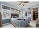 Comfortable bedroom with blue walls, large bed, and view to backyard and walk-in closet at 2240 W Dale Cir, Deland, FL 32720