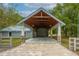 Open carport with wooden ceiling and pillars and a brick driveway leading up to it at 2240 W Dale Cir, Deland, FL 32720