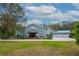 Charming two-story home showcasing a manicured lawn and a spacious three-car garage at 2240 W Dale Cir, Deland, FL 32720