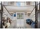 Grand foyer showcasing a split staircase, elegant decor, and a glimpse of the inviting pool area at 2240 W Dale Cir, Deland, FL 32720
