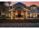 Inviting home entrance featuring a covered porch with stone pillars and a meticulously patterned paver walkway at 2240 W Dale Cir, Deland, FL 32720