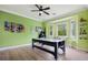 Spacious game room with hardwood floors, green walls, air hockey table, and natural light at 2240 W Dale Cir, Deland, FL 32720