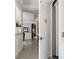 Hallway with white walls, elevator access, and a view of the adjacent living room at 2240 W Dale Cir, Deland, FL 32720