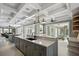 Expansive kitchen with double islands, premium finishes, and access to outdoor spiral staircase and pool area at 2240 W Dale Cir, Deland, FL 32720