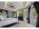 Comfortable main bedroom features a large bed, a television, dark curtains and access to a private balcony at 2240 W Dale Cir, Deland, FL 32720