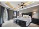 Spacious bedroom with tray ceiling, dark wood furniture, ample natural light, and access to balcony at 2240 W Dale Cir, Deland, FL 32720
