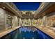 Beautifully lit courtyard pool surrounded by the house at twilight at 2240 W Dale Cir, Deland, FL 32720