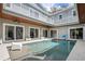 Bright courtyard pool surrounded by the house with plenty of seating and natural light at 2240 W Dale Cir, Deland, FL 32720