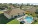Aerial view of a home with a fenced pool, patio, and lush green lawn at 2662 Haulover Blvd, Deltona, FL 32738