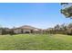 Wide backyard shot showing the in-ground pool, a fenced-in yard, and a lush green lawn at 2662 Haulover Blvd, Deltona, FL 32738