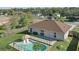 Aerial view of the backyard featuring a private pool, patio area, and lush greenery at 2662 Haulover Blvd, Deltona, FL 32738