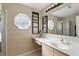 Bright bathroom featuring a modern sink, octagon window, and large vanity mirror at 2662 Haulover Blvd, Deltona, FL 32738