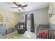 Cozy Bedroom with tile floors, a ceiling fan, and comfortable rocking chair at 2662 Haulover Blvd, Deltona, FL 32738